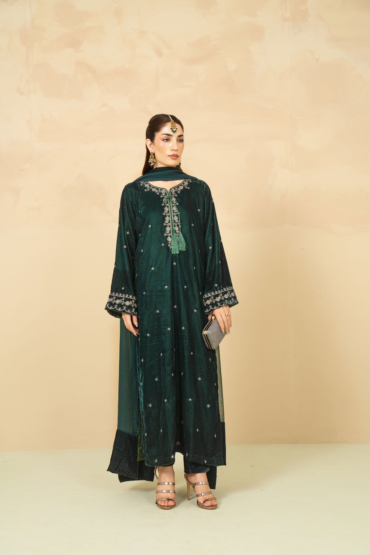 Model wearing Laila bottle green velvet suit