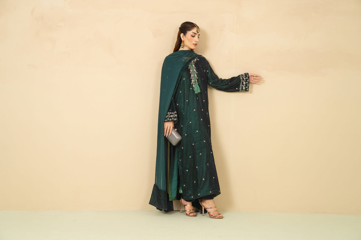 Model wearing Laila bottle green velvet three piece
