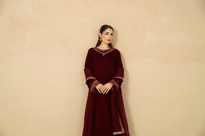 Model wearing Gul-e-Rana maroon velvet three piece
