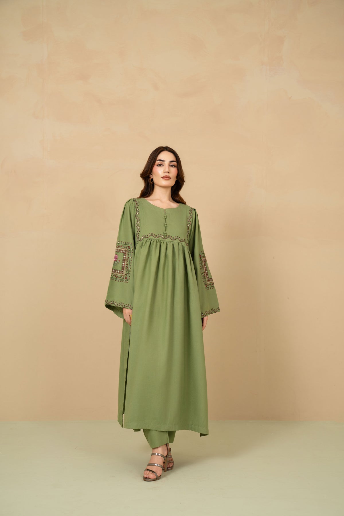 Model wearing Celadon sage green flared suit