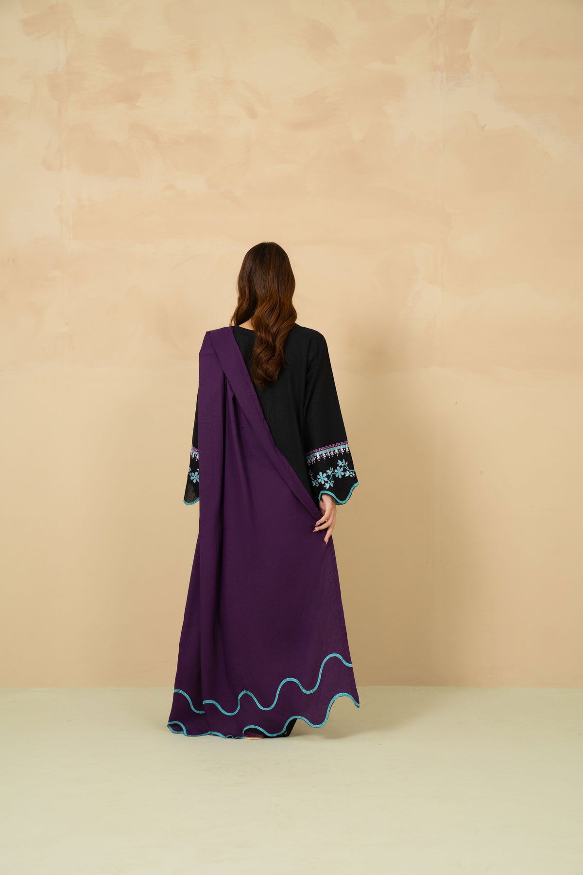 Model wearing Noir black farshi shalwar suit